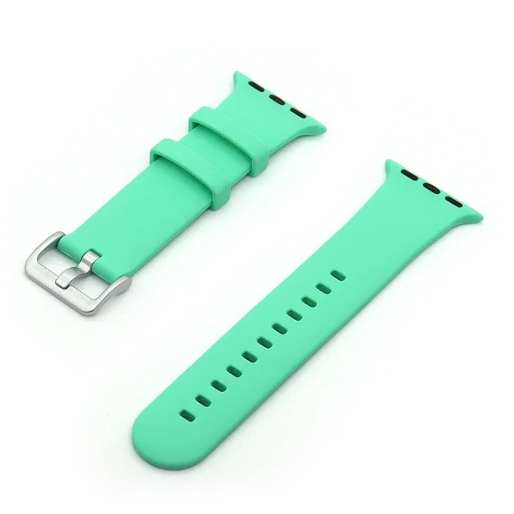 Silver buckle silicone replacement watch strap in mint green color, designed for comfort and easy adjustment for Apple Watch models.