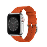 Two-color nylon braid replacement watch strap for Apple Watch showcasing a bright orange band on a black watch face.